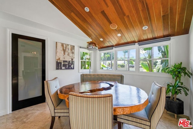 tiled dining space with wood ceiling and vaulted ceiling