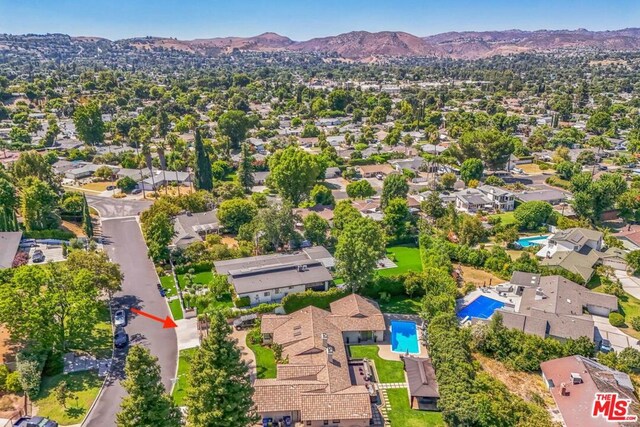 birds eye view of property with a mountain view