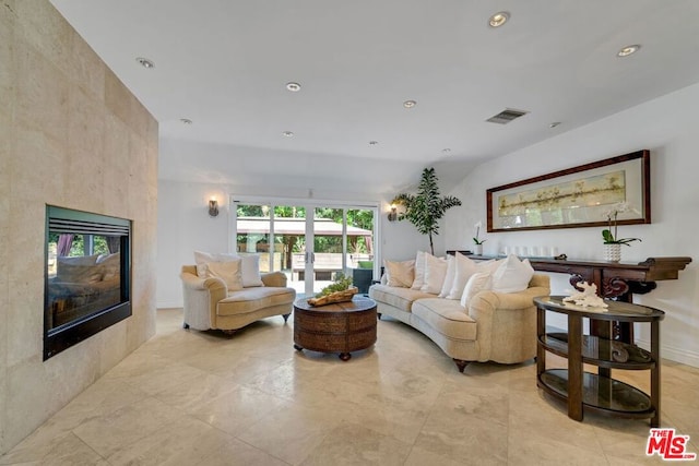 living room featuring a tile fireplace