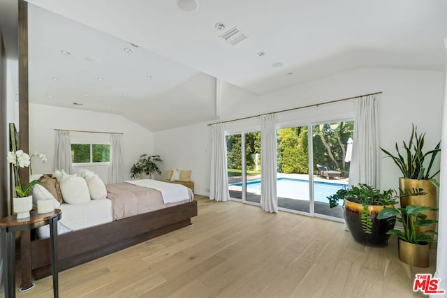 bedroom with vaulted ceiling, access to exterior, and light hardwood / wood-style flooring