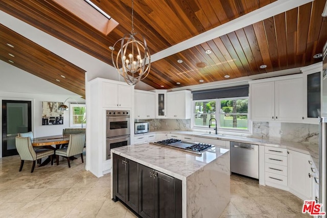 kitchen featuring light stone countertops, white cabinets, wood ceiling, a kitchen island, and stainless steel appliances