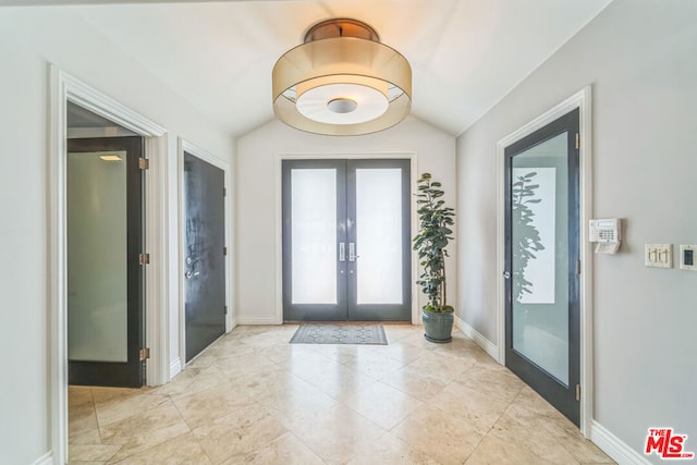 doorway with lofted ceiling and french doors