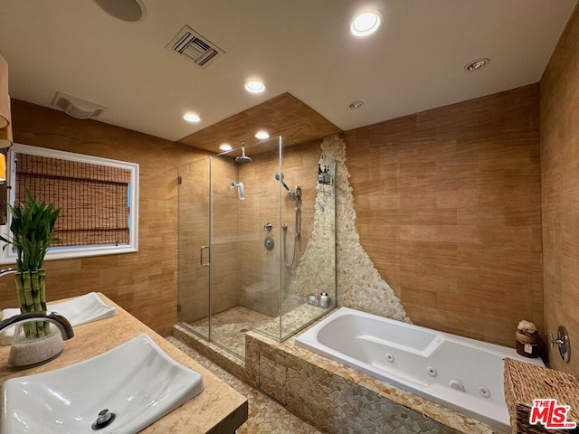 bathroom with sink and plus walk in shower