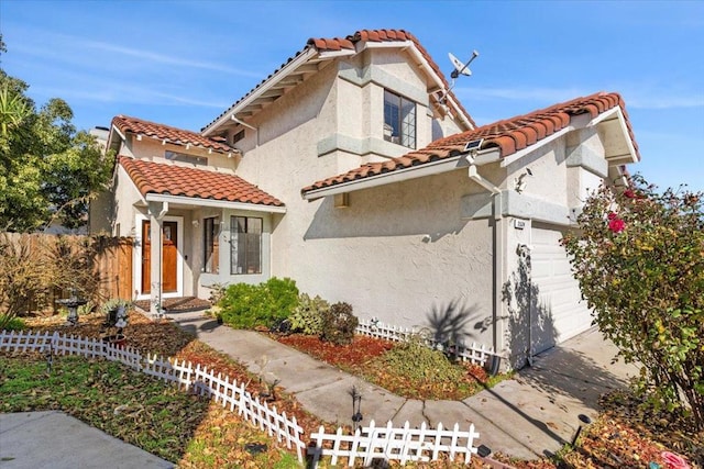 mediterranean / spanish-style home with a garage