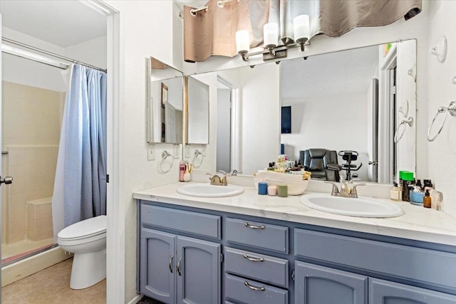 bathroom with toilet, vanity, tile patterned flooring, and curtained shower