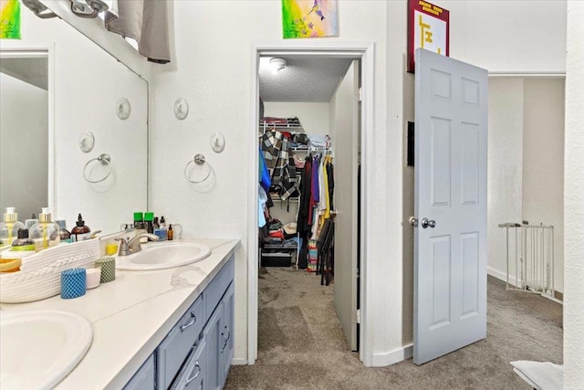 bathroom featuring a textured ceiling and vanity