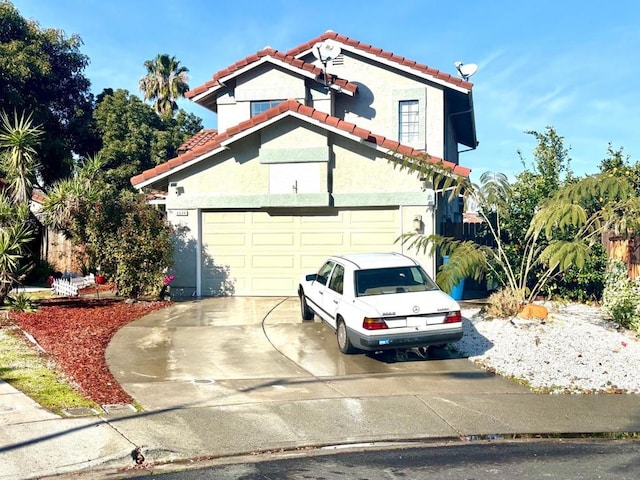 mediterranean / spanish house featuring a garage