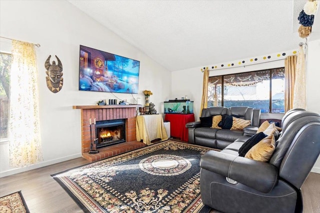 living room featuring a brick fireplace, lofted ceiling, and light hardwood / wood-style flooring