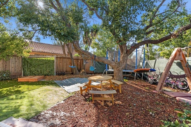 view of yard featuring a trampoline and a patio area