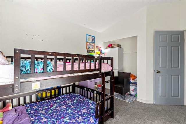 bedroom featuring vaulted ceiling and carpet flooring