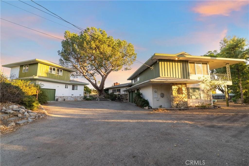 view of property featuring a balcony and a garage