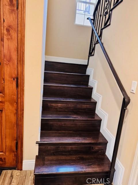 stairway featuring wood-type flooring