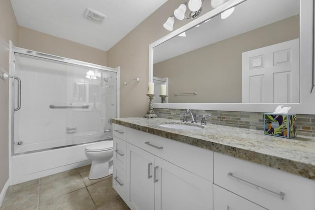 full bathroom featuring enclosed tub / shower combo, tile patterned floors, vanity, decorative backsplash, and toilet