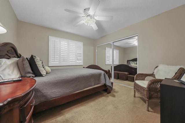 carpeted bedroom featuring ceiling fan and a closet