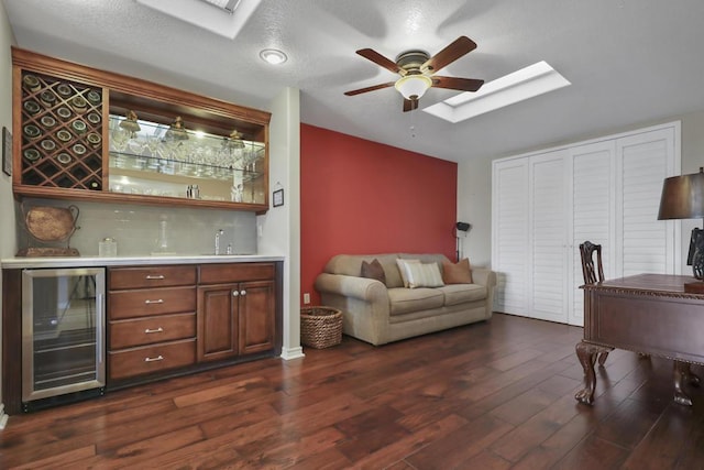 bar with ceiling fan, dark hardwood / wood-style floors, wine cooler, a textured ceiling, and sink