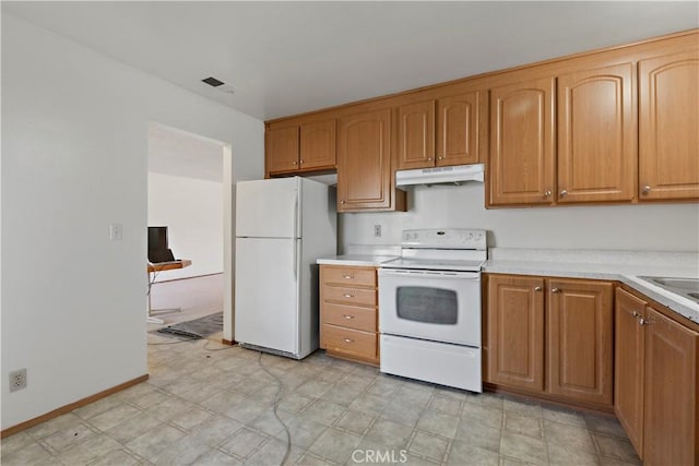 kitchen featuring white appliances, under cabinet range hood, visible vents, and light countertops