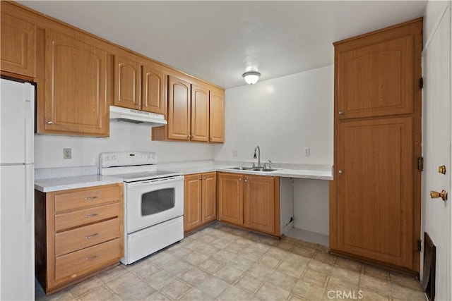 kitchen with white appliances, light countertops, a sink, and under cabinet range hood