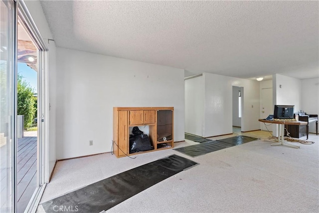 living room featuring light carpet and a textured ceiling