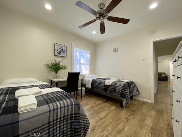 bedroom featuring ceiling fan and light hardwood / wood-style flooring