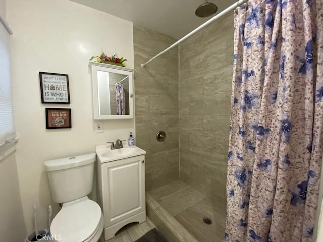 bathroom with toilet, vanity, and a shower with curtain