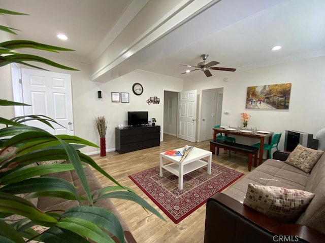 living room featuring light wood-type flooring, ceiling fan, and ornamental molding