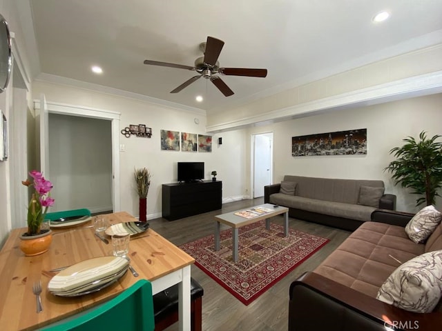 living room featuring dark wood-type flooring, ornamental molding, and ceiling fan