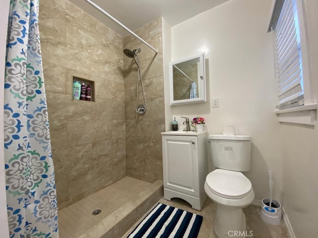 bathroom with toilet, vanity, a shower with curtain, and tile patterned flooring