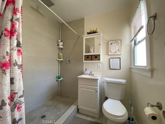 bathroom with tile patterned floors, toilet, vanity, and a shower with curtain