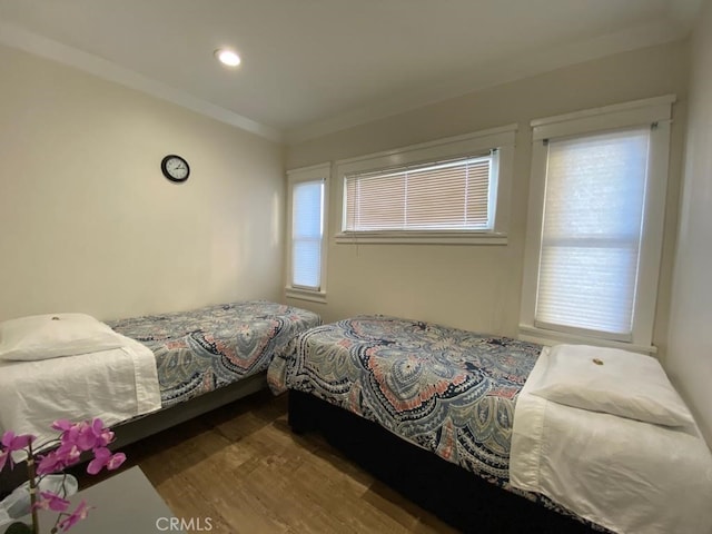 bedroom with hardwood / wood-style floors and ornamental molding