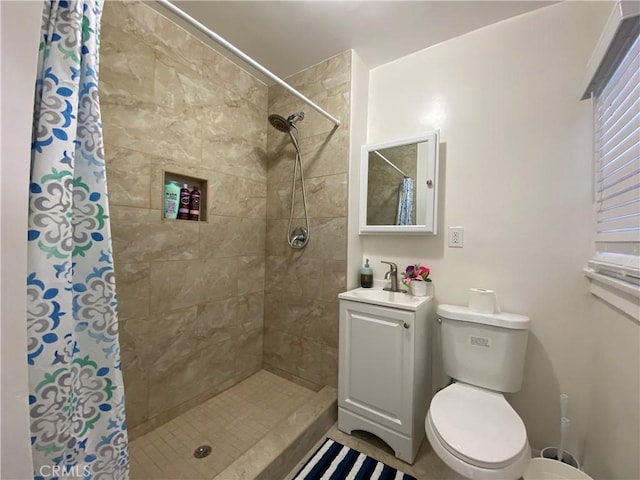 bathroom featuring toilet, walk in shower, and vanity