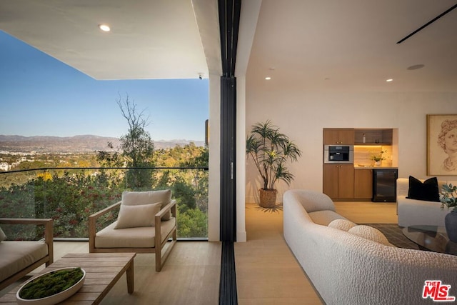 balcony featuring an outdoor hangout area, wine cooler, and a mountain view