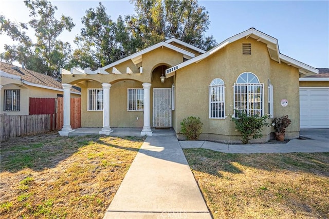 view of front of property with a front yard and a garage