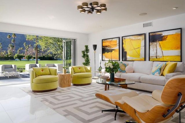 tiled living room featuring a notable chandelier