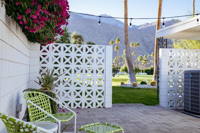 view of patio / terrace featuring cooling unit and a mountain view