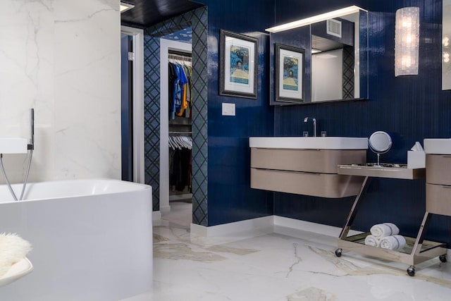 bathroom with vanity and a bath