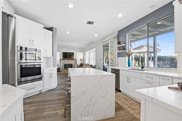 kitchen featuring sink, white cabinets, dark hardwood / wood-style floors, and a kitchen island