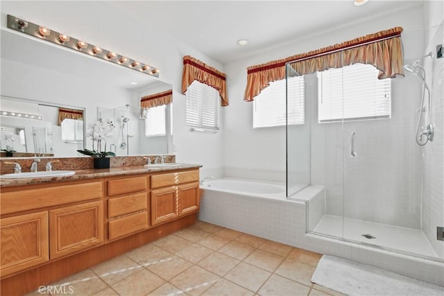 bathroom with independent shower and bath, tile patterned flooring, and vanity