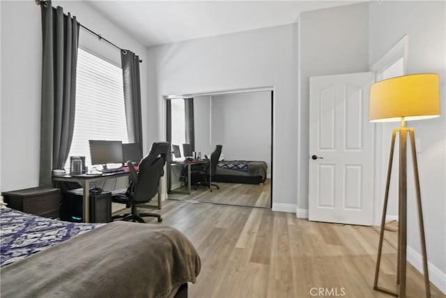 bedroom featuring light wood-type flooring and a closet