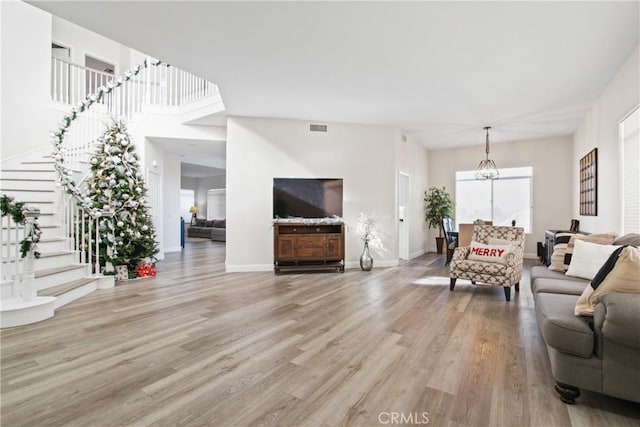 living room featuring a chandelier and hardwood / wood-style floors