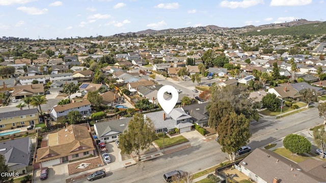 birds eye view of property featuring a mountain view