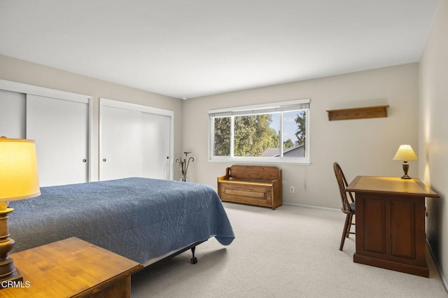 carpeted bedroom featuring multiple closets