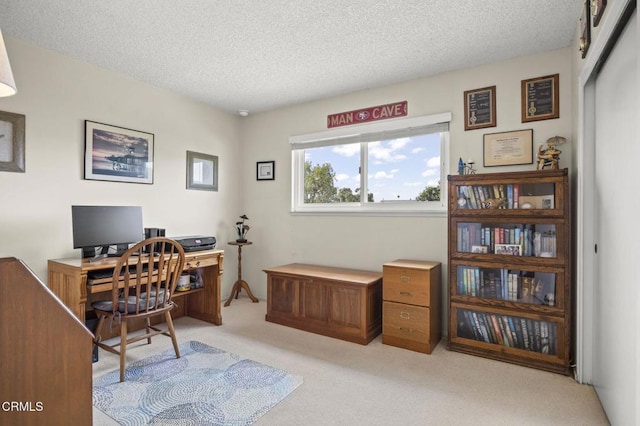 office area featuring a textured ceiling and light colored carpet