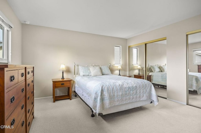 carpeted bedroom with two closets