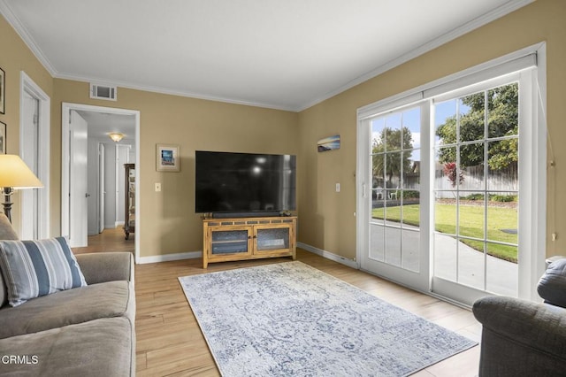 living room with crown molding and light hardwood / wood-style floors