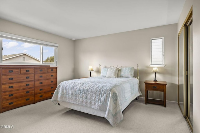 bedroom featuring light carpet and a closet