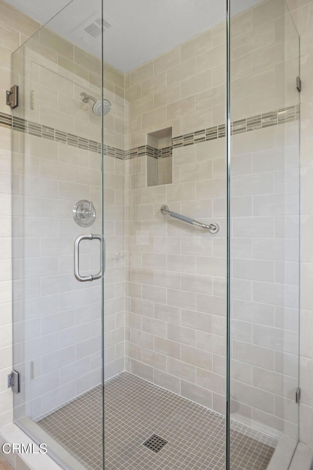 bathroom with a shower with shower door