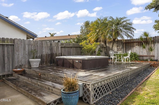 wooden deck featuring a hot tub