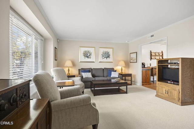 carpeted living room featuring ornamental molding