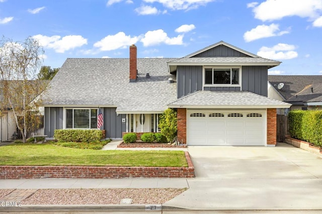 view of front of home with a front yard and a garage