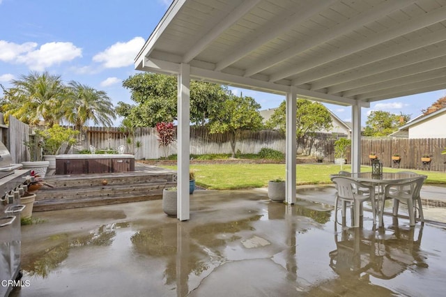 view of patio / terrace with a water view and a hot tub